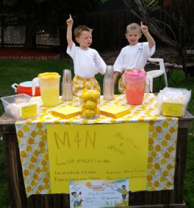 Two very young boys run a lemonade stand, proving it's never too early to start a business.