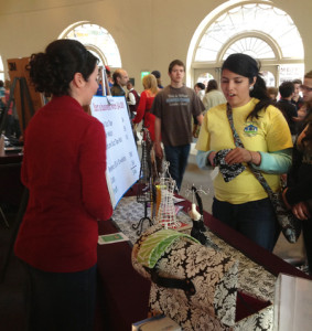 Ariane Vigil talks to Youth Council member Luz Castaneda about her business.