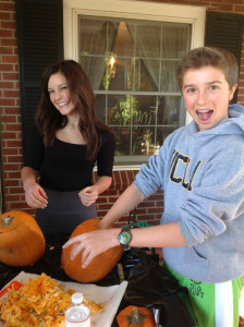 Kaylee and Jack are arm-deep in pumpkin seeds!