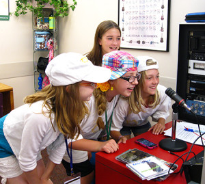 Summer campers enjoy their jobs in the Radio Station.