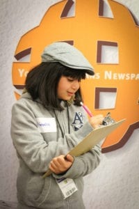 An AmeriTowne Newspaper Reporter works on a story