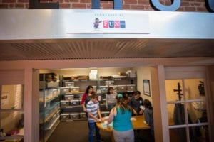 Many students are shown smiling and working in the Fun Services YAT shop. Fun Services, a local Colorado company, plays a big role in providing this real-life experience for thousands of young people every year.