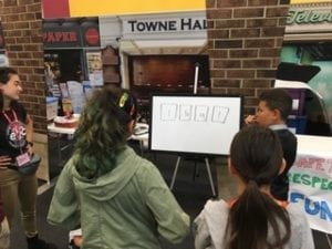 Students stand together in front of Town Hall talking together