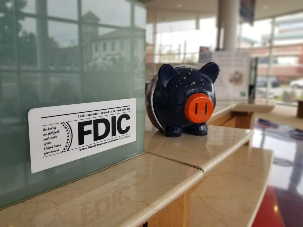 FDIC sticker with piggy bank in foreground
